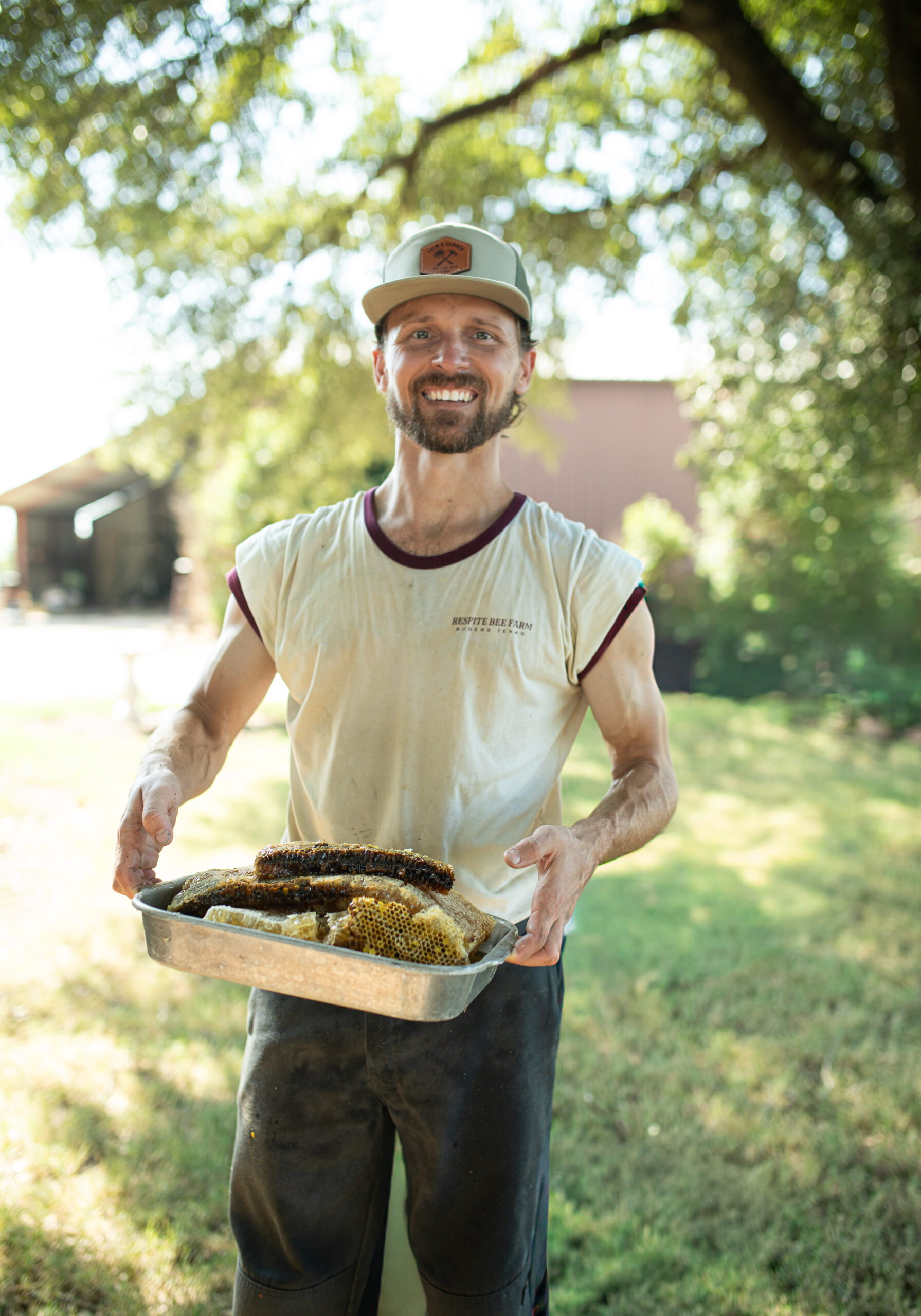 Ben Baecker holding a bees after a removal